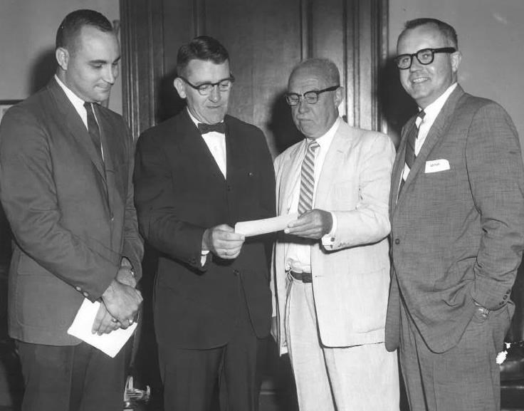 Presenting check for Borda Wing left to right: Ernie Cooke PhD, Judge William Gallogly, Earl W. G. Horward, and Donald Ford.