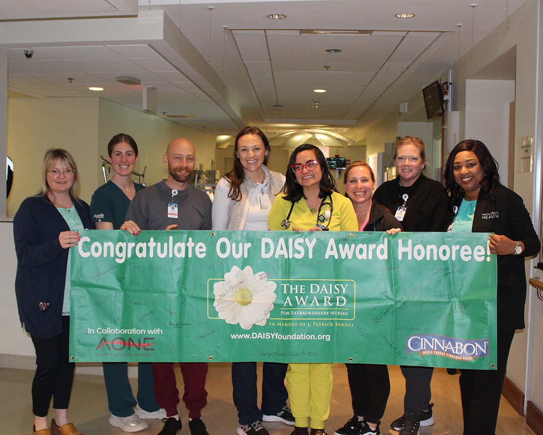 DAISY Award recipient Maddie Glidden, RN, with her nursing colleagues and leaders.