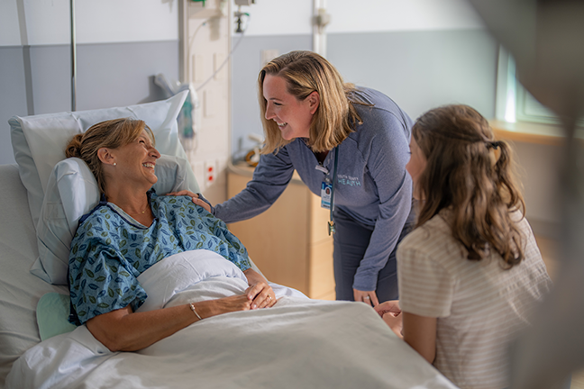 Rianne Berke, RN, visits a patient's bedside at South County Hospital 
